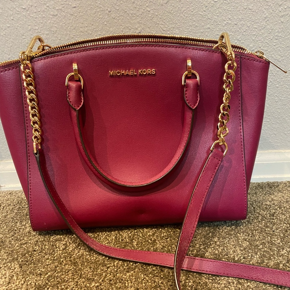 Like new raspberry colored Michael Kors hand bag.